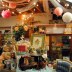 The photo features a decorated booth with hanging paper balls from the ceiling and an organized table with various items piled on top.