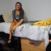 Whitney Garcia sits on top of her bed in her dorm room at Taylor Place in downtown Phoenix.