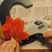 The picture shows one glueing the fake leaves onto the letter with the glue gun.